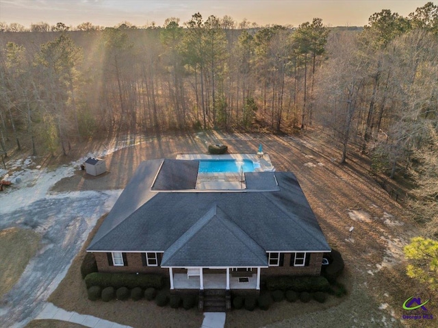 drone / aerial view featuring a forest view