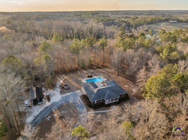 drone / aerial view with a wooded view