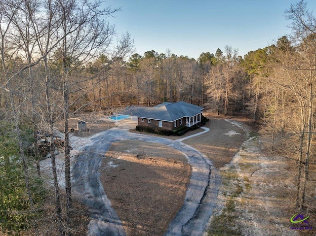 birds eye view of property with a wooded view