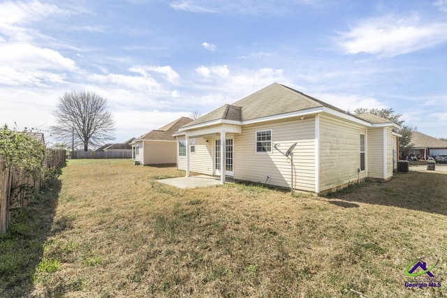 rear view of property featuring a patio area, a fenced backyard, a lawn, and central air condition unit