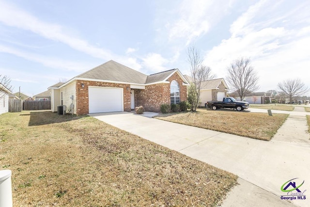 ranch-style house with a garage, brick siding, fence, driveway, and a front lawn