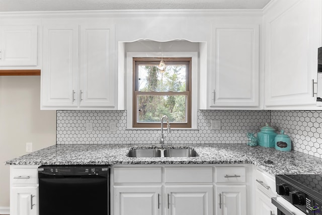 kitchen with black dishwasher, tasteful backsplash, a sink, and white cabinetry