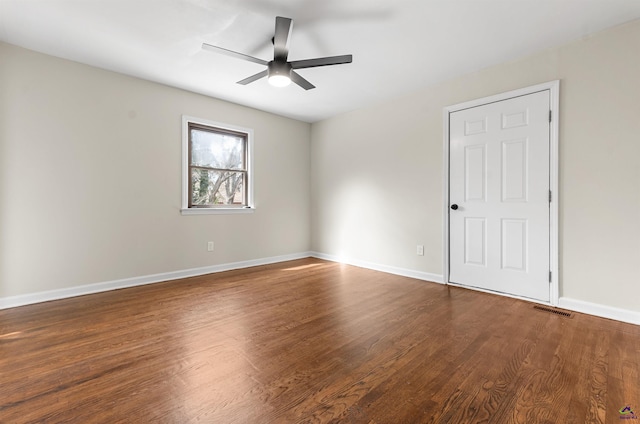 unfurnished room featuring visible vents, ceiling fan, baseboards, and wood finished floors