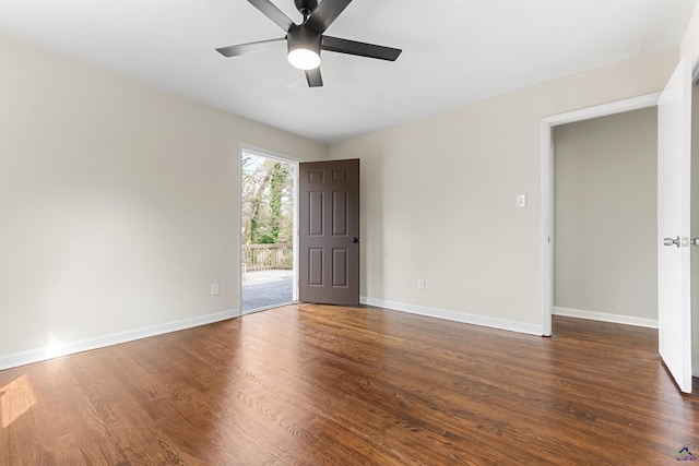 empty room with dark wood-style floors, ceiling fan, and baseboards