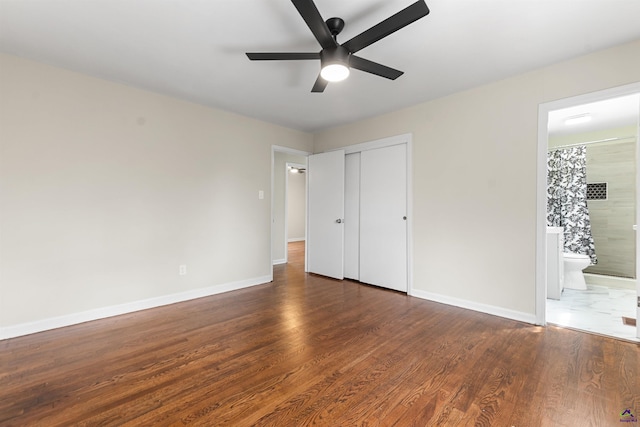 unfurnished bedroom featuring a ceiling fan, a closet, baseboards, and wood finished floors