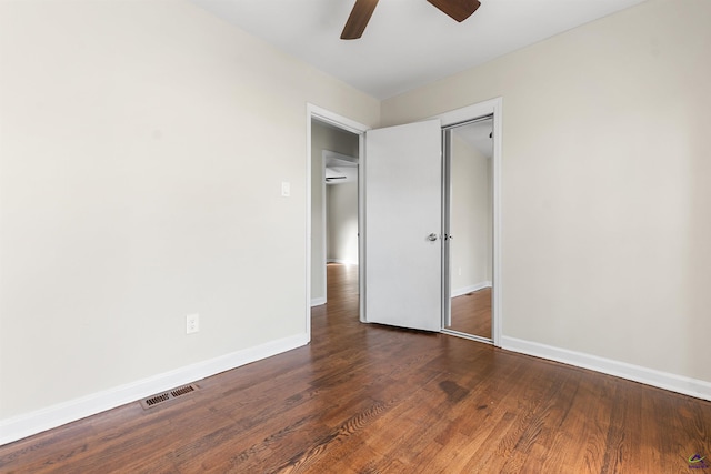 unfurnished bedroom featuring a closet, visible vents, a ceiling fan, wood finished floors, and baseboards