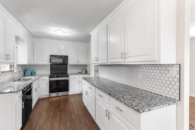 kitchen featuring black appliances, dark wood-style flooring, a sink, and white cabinetry