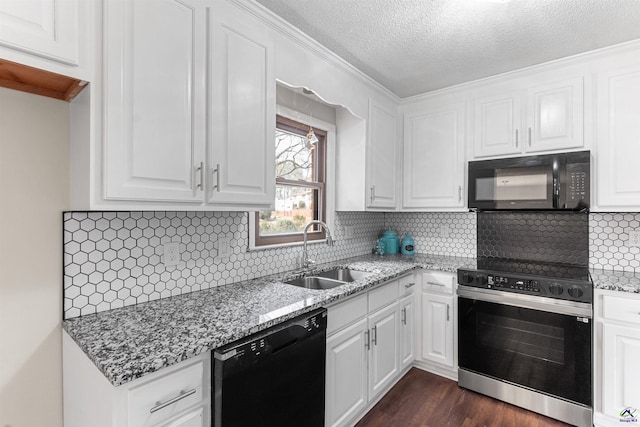 kitchen with dark wood-style flooring, white cabinetry, a sink, light stone countertops, and black appliances