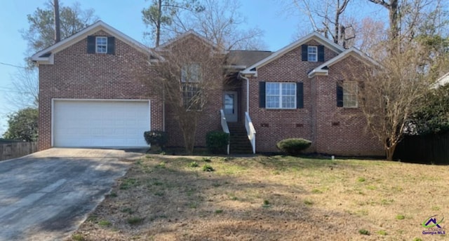 view of front of home with a front yard, brick siding, and driveway