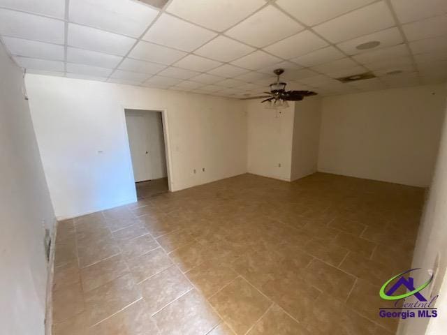 unfurnished room featuring a drop ceiling and a ceiling fan