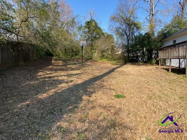 view of yard with fence and a deck