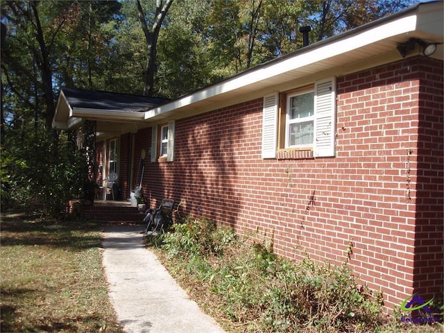 view of property exterior featuring brick siding