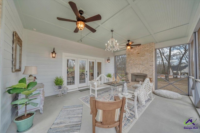 sunroom / solarium with a ceiling fan and french doors