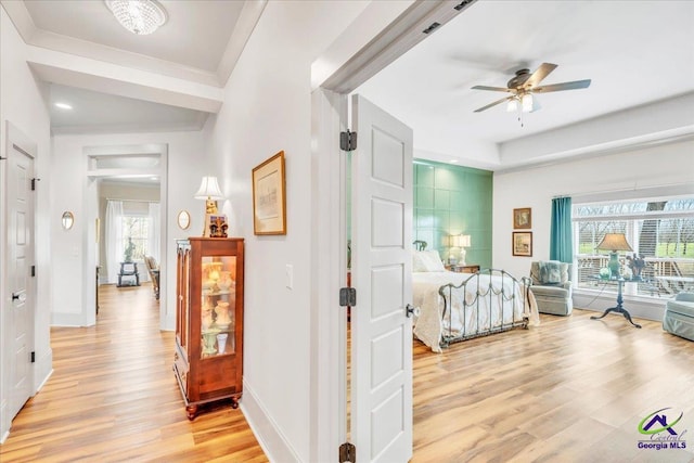 bedroom featuring light wood finished floors and baseboards