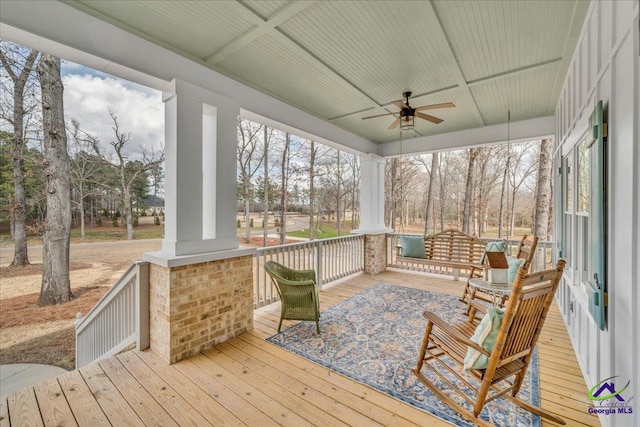 sunroom / solarium with a ceiling fan