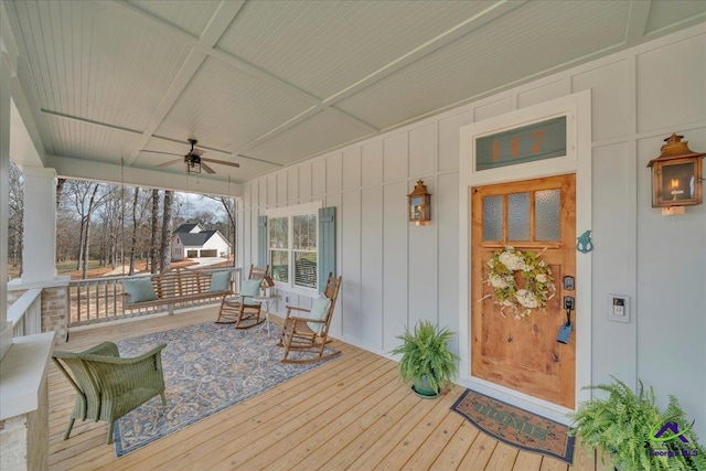 wooden deck with ceiling fan and a porch