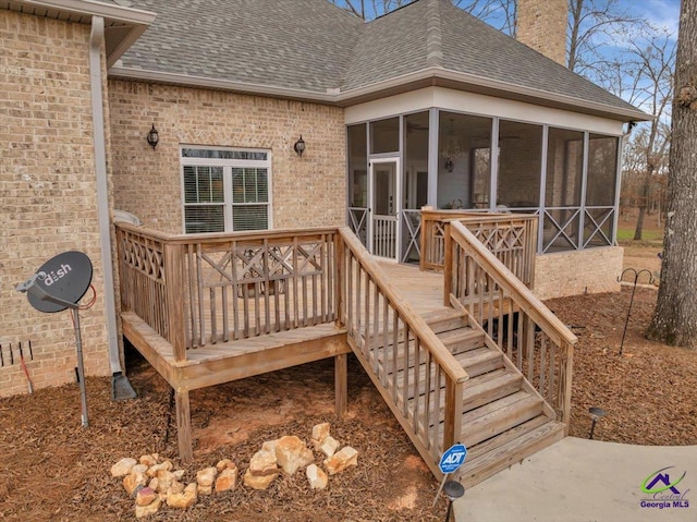 wooden terrace featuring a sunroom and stairs