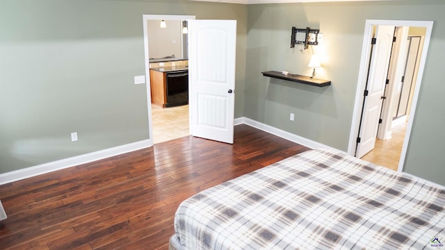 bedroom with baseboards and wood finished floors