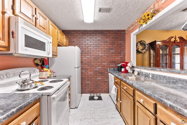 kitchen with marble finish floor, visible vents, a sink, a textured ceiling, and white appliances