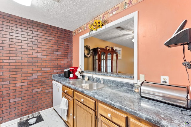 kitchen featuring a textured ceiling, brick wall, a sink, marble finish floor, and dishwasher