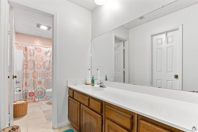 bathroom with a shower with shower curtain, toilet, a textured ceiling, vanity, and tile patterned flooring