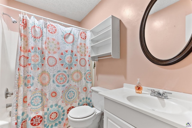 full bathroom featuring a textured ceiling, vanity, and toilet