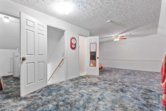 unfurnished room featuring ceiling fan, a textured ceiling, vaulted ceiling, and carpet flooring