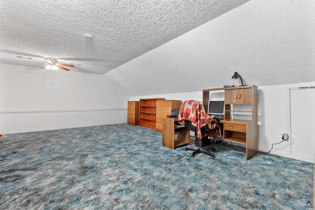 office area featuring vaulted ceiling, a textured ceiling, carpet, and a ceiling fan