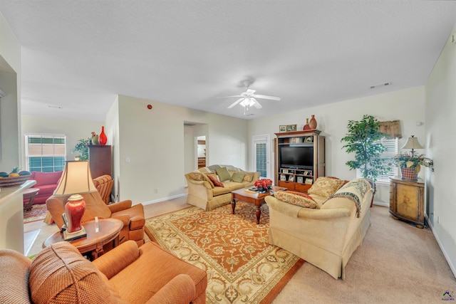 living room with a healthy amount of sunlight, visible vents, and light colored carpet