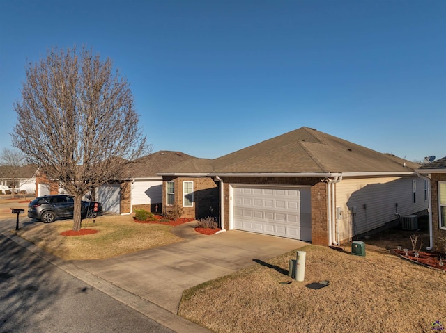 single story home with a shingled roof, concrete driveway, an attached garage, cooling unit, and brick siding