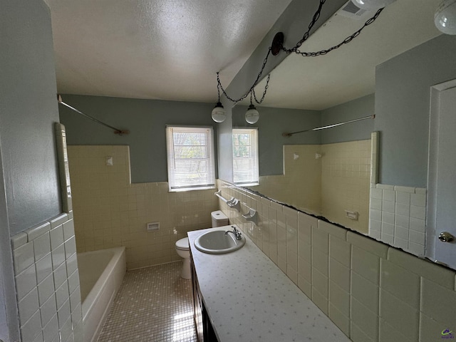 full bathroom featuring a textured ceiling, toilet, tile walls, tile patterned floors, and washtub / shower combination