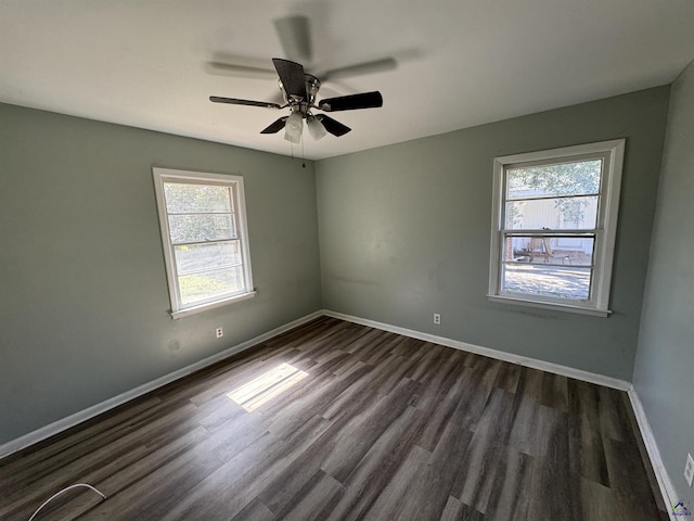 unfurnished room featuring a ceiling fan, baseboards, and dark wood-style flooring