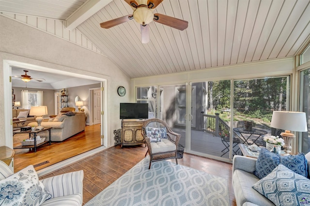 living room featuring lofted ceiling with beams, a sunroom, and hardwood / wood-style flooring