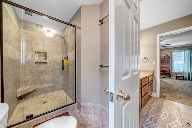 full bathroom featuring baseboards, toilet, tile patterned flooring, vanity, and a shower stall