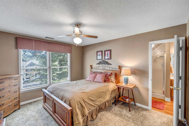 bedroom featuring baseboards, visible vents, and light colored carpet