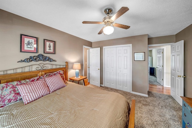 bedroom featuring a textured ceiling, ceiling fan, carpet floors, baseboards, and a closet