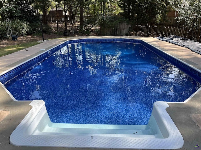 view of swimming pool featuring fence and a fenced in pool