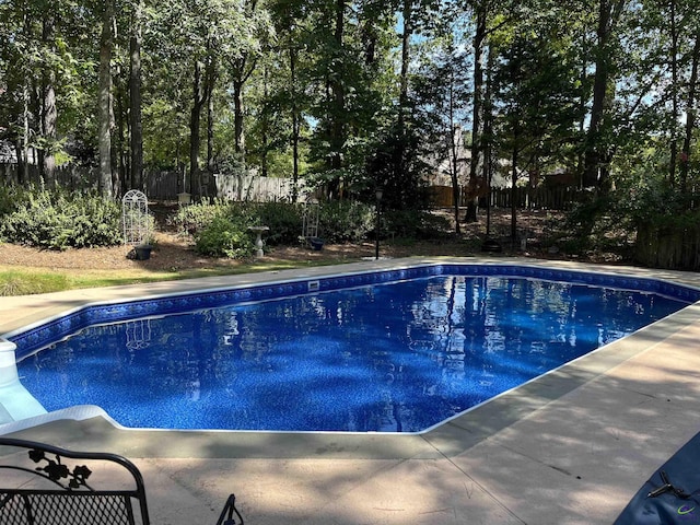 view of swimming pool featuring fence and a fenced in pool