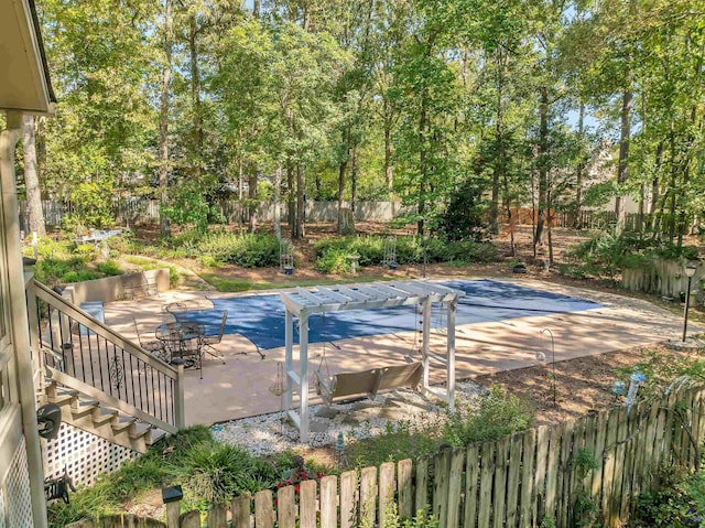 view of swimming pool with fence private yard and a patio