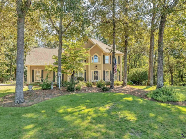 view of front of house featuring a front lawn and stucco siding