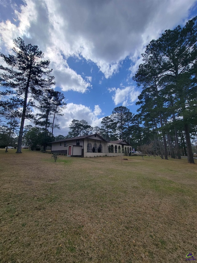 exterior space featuring an attached garage and a front lawn