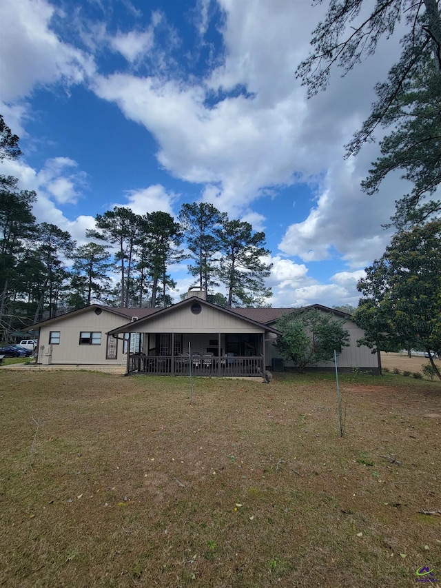 back of house with a yard
