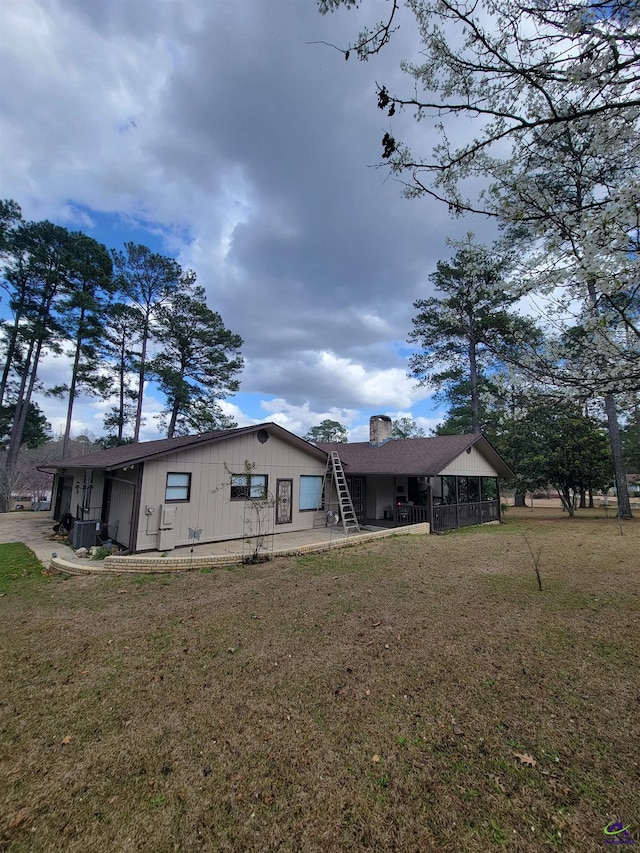 rear view of house with a porch and a lawn
