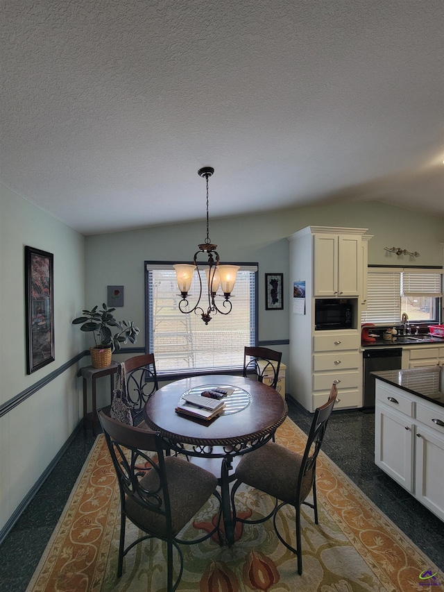 dining room featuring a healthy amount of sunlight, a notable chandelier, and a textured ceiling