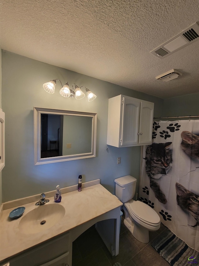 bathroom with visible vents, toilet, a textured ceiling, vanity, and tile patterned floors