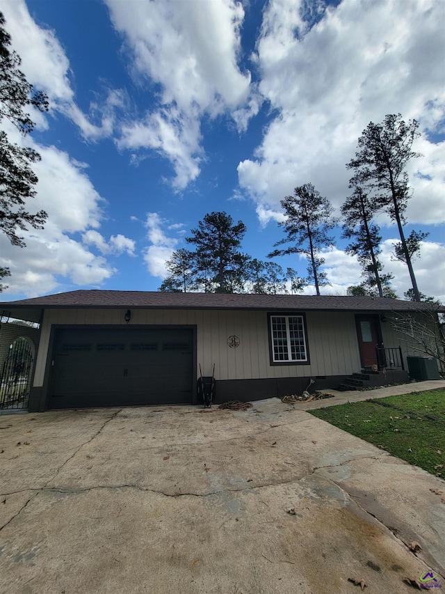 ranch-style house featuring a garage and driveway