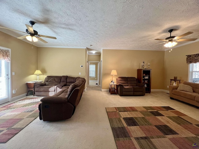 living room with a textured ceiling, baseboards, crown molding, and light colored carpet