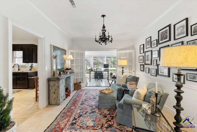 living area featuring french doors, crown molding, light colored carpet, visible vents, and an inviting chandelier