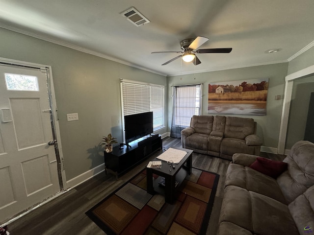 living area featuring ceiling fan, visible vents, baseboards, dark wood-style floors, and crown molding