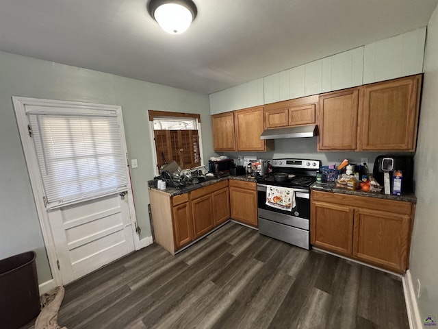 kitchen featuring under cabinet range hood, brown cabinets, dark wood-type flooring, and stainless steel range with electric cooktop